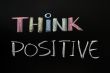 Think positive - text written with chalk on blackboard