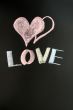 Love with two hearts drawn on a chalkboard