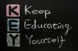KEY acronym -Keep educating yourself on a blackboard with words written in chalk. 