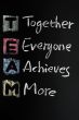 TEAM acronym written in colorful chalk
