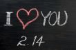 Love with valentine `s date drawn on a chalkboard