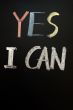 Chalk handwriting of `YES I CAN` on a blackboard 