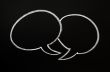 Two speech bubbles on a blackboard