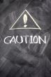 Caution written on blackboard