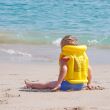 Liitle boy on the beach in lifejacket