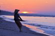 Silhouette of a fisherman on beach at sunrise