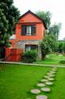 Red house with green meadows
