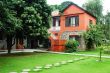 Red house with green meadows