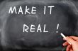 Make it real with a hand holding chalk