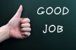 Thumb up with good job written on a blackboard