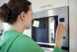 woman cooking with a microwave in a modern kitchen