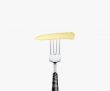 baby corn pierced by fork,  isolated on white background 