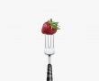 strawberry  pierced by fork,  isolated on white background 