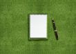 Blank notebook on grass