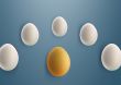 unique golden egg between white eggs