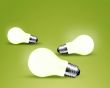 Three glowing Light bulb idea on green background