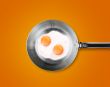 Two Fried eggs in a frying pan