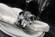 Decorative folded napkin on a plate with cutlery