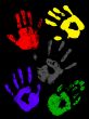 Colorful handprints on a black background