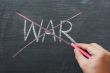 War - word crossed out with red chalk 