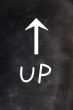 Up - word written on a blackboard with an arrow