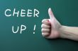Cheer up written on a blackboard background