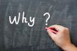 Why - written on a smudged chalkboard with chalk