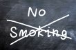 No smoking written on a smudged blackboard