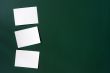 Blank stick note on a green board