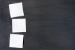 Blank stick note on a blackboard