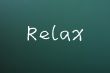 Relax - word written on a blackboard