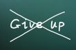 Do not give up, words written on blackboard 