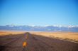 Empty freeway approaching mountains range