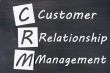 Acronym of CRM - Customer Relationship Management written on a blackboard 