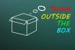 Concept of `Think Outside the box` drawn with chalk on a blackboard 