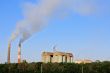 Smoke stacks of cement factory. Summertime landscape