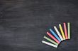 Colorful chalk on a blank smudged blackboard