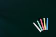 Colorful chalk on a green chalkboard