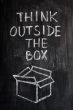 Concept of `Think Outside the box` drawn with chalk on a blackboard 