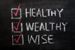 Being healthy, wealthy and wise written with chalk on a blackboard