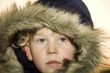 Little boy wearing a fur lined hood