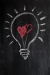 Lightbulb drawn with chalk on a chalkboard symbolizing love