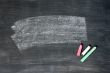 Smudged blackboard background with chalk and copy space