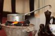 Roasting raw coffee using coal