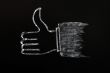 Chalk drawing of thumb up sign on blackboard background