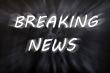 Breaking news written with motion rays on retro blackboard background 
