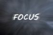 Focus word with motion rays on retro blackboard background 