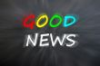 Chalk drawing of `Good news` on blurred chalkboard 