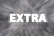Chalk drawing of `Extra` word written on blurred chalkboard 