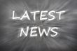 Chalk drawing of `Latest news` on blurred chalkboard 